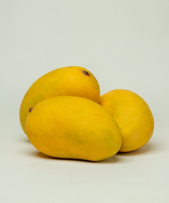 Whole Chaunsa mango with yellow skin, ready to be enjoyed with its sweet and tangy flavor.